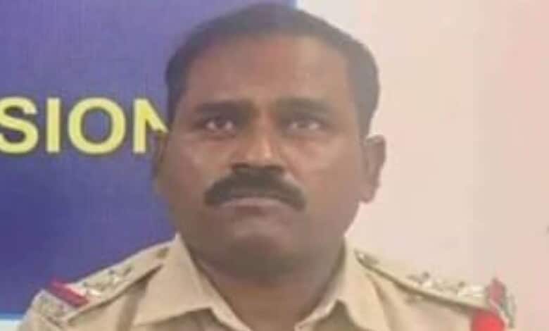 Police officer with a serious expression in uniform, related to Warangal CP suspension news.