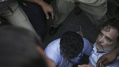 Protesters and police officers in a tense confrontation during a demonstration in Delhi.