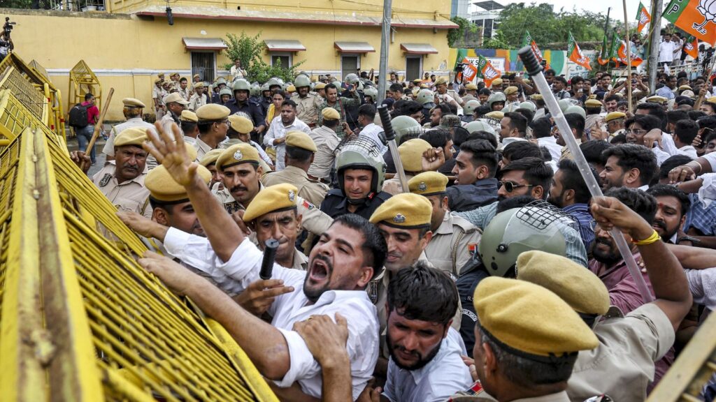 Protesters clash with police during student agitation in India, with police using barriers to control the.