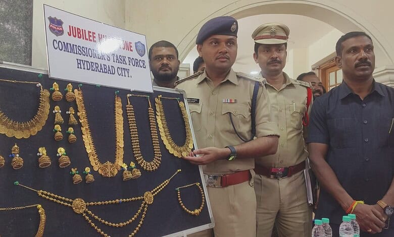 Police officers display gold jewelry recovered from theft in Hyderabad.