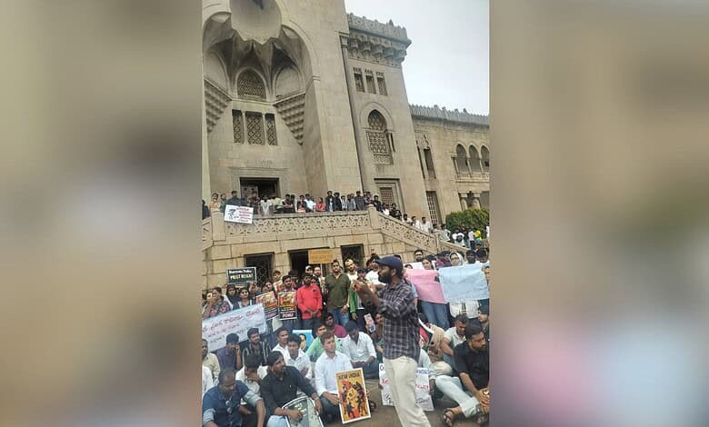 Hyderabad student leaders protest outside a historic building with banners and placards.