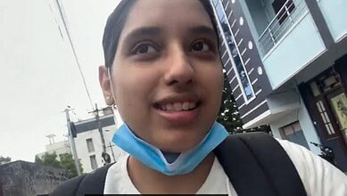 Disha visiting Jantar Mantar with a face mask hanging below her chin.