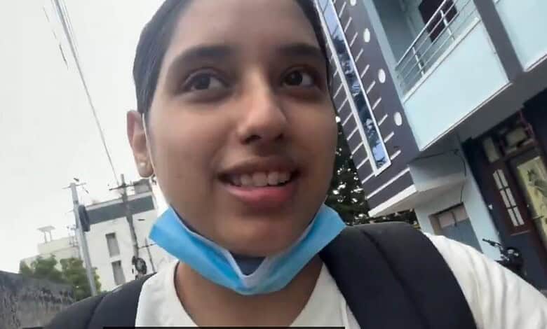 Disha visiting Jantar Mantar with a face mask hanging below her chin.