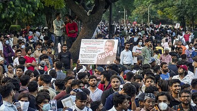 Large crowd of protesters with signs and banners during a demonstration in India.
