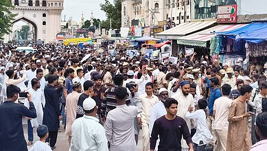 Large crowd protesting at Charminar over NEET paper leak in Hyderabad.