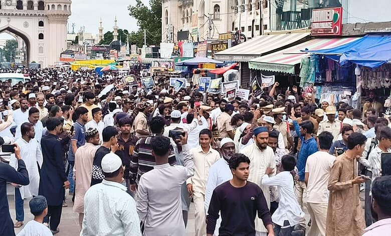 Large crowd protesting at Charminar over NEET paper leak in Hyderabad.