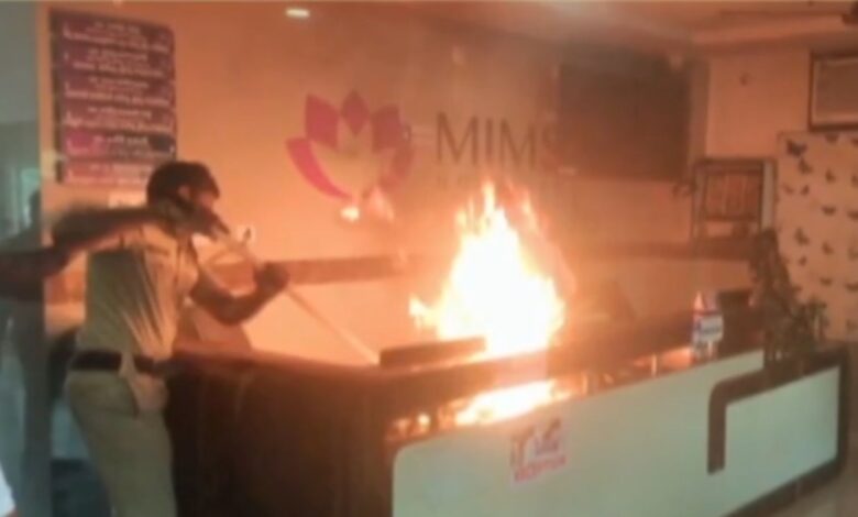 Hospital reception set ablaze with flames and smoke during a protest in Telangana.