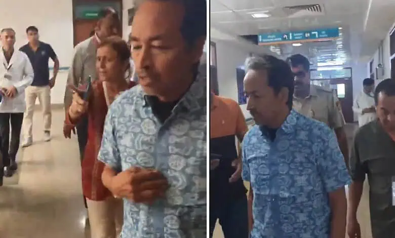 Sonam at hospital, surrounded by staff and visitors, appears distressed and is being stopped by security.