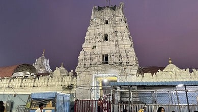 Ancient Dakshina Kashi temple under renovation with scaffolding and construction site.