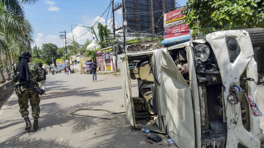 Damaged vehicle on the street after police action during NEET bandh violence in Bihar.