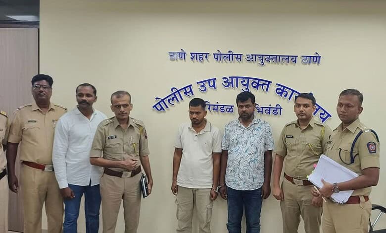 Group of police officers and civilians standing in front of a wall with Marathi text.