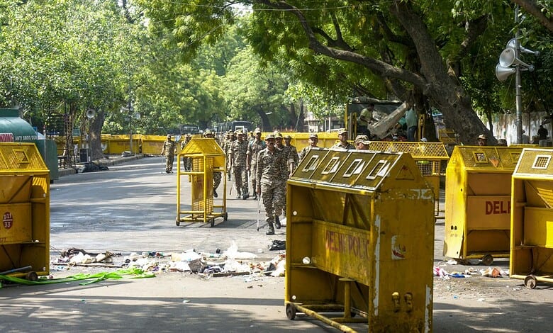 Police barricades and personnel at the scene during a protest at Jantar Mantar.