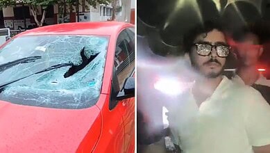 Damaged red car with shattered windshield after accident in Rajendranagar.