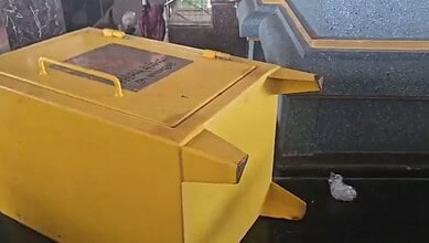 Yellow donation box with a lock, placed outside a temple in Hyderabad.