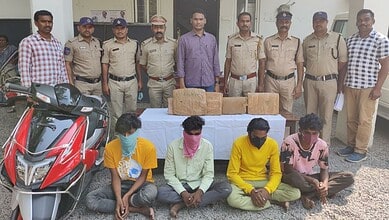 Police officers and three suspects with seized ganja in Khammam, India.
