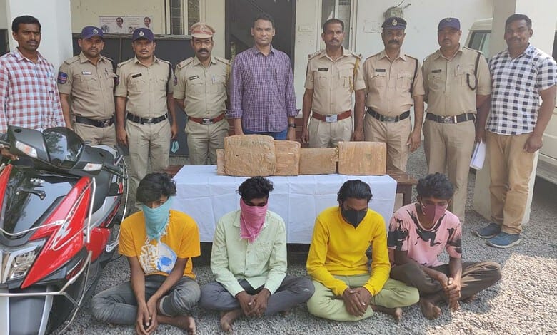 Police officers and three suspects with seized ganja in Khammam, India.