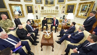 U.S. President Trump and Ukrainian President Zelenskyy meet with officials in a decorated room.