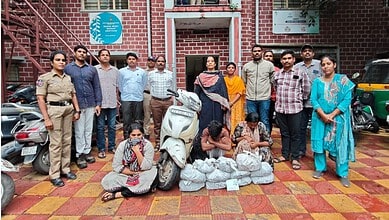 Police and officials display seized 9 kg ganja in Hyderabad with suspects and evidence.