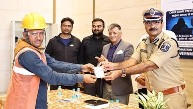 Construction workers receive BOCW welfare cards from police officials in Hyderabad.
