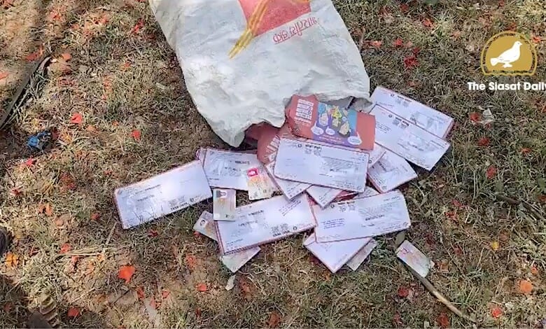 Abandoned voter ID cards scattered on the ground in Hyderabad.