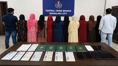 Group of women and men facing a police banner at Central Crime Branch Bengaluru City.