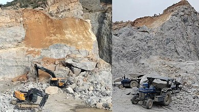 Construction site with excavators and trucks near a rocky quarry.