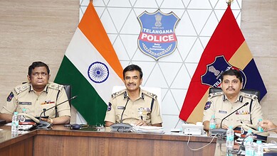 Telangana DGP Anand reviews policing with senior officers in a conference room.