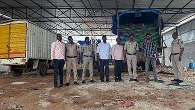 Police officers and officials inspect seized PDS rice and wheat in Hyderabad.