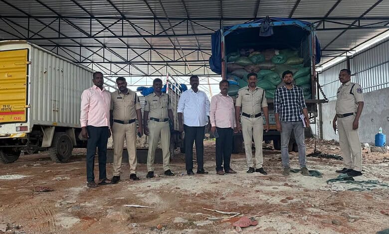 Police officers and officials inspect seized PDS rice and wheat in Hyderabad.