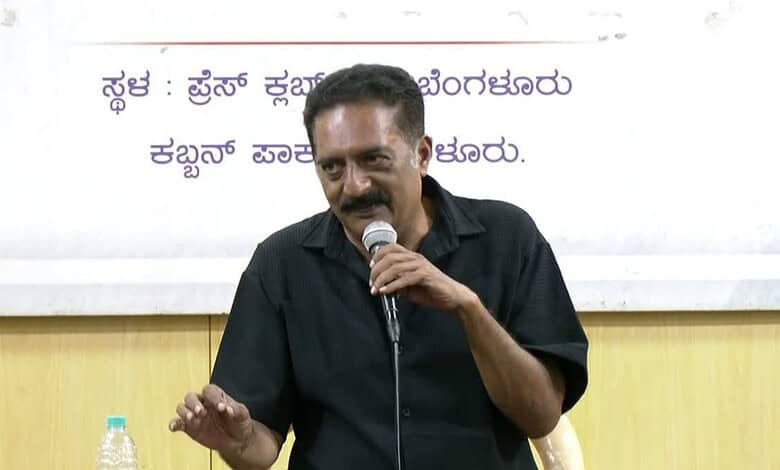 Prakash Raj speaking into a microphone during a court appearance in Bengaluru.