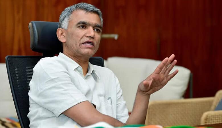 Bengaluru minister speaking during a press conference about property tax issues.