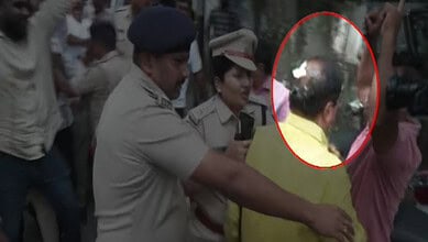 Police officers and a man with a yellow shirt in a tense scene during a protest.
