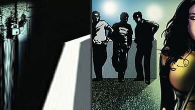 Four individuals standing in a dimly lit corridor, with a woman partially visible on the right.