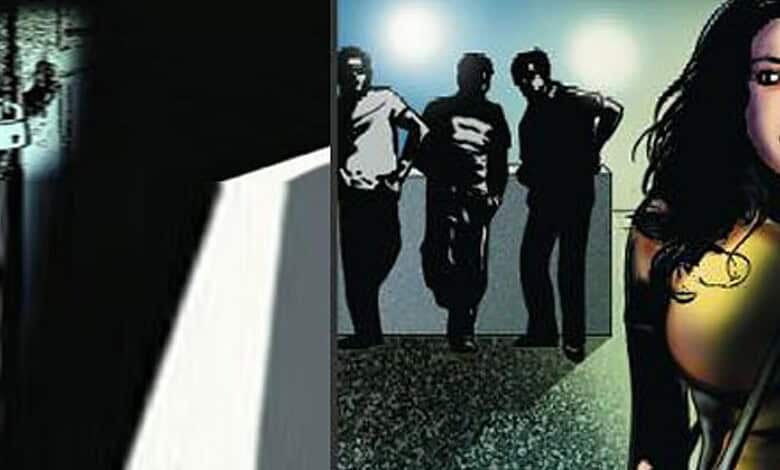 Four individuals standing in a dimly lit corridor, with a woman partially visible on the right.
