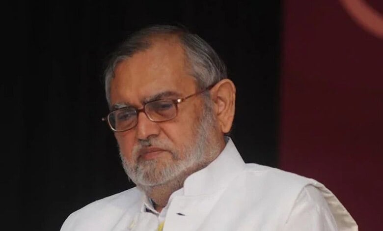 Zafarul-Islam Khan with a serious expression at the award ceremony.