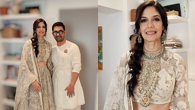 Gauri Spratt in traditional wedding attire with a smiling guest at her wedding.