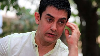 Aamir Khan in a candid moment during an outdoor interview or event.