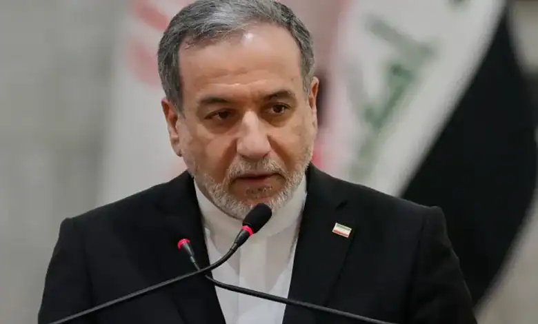 Iranian Foreign Minister Abbas Araghchi speaks at a podium during an official event.