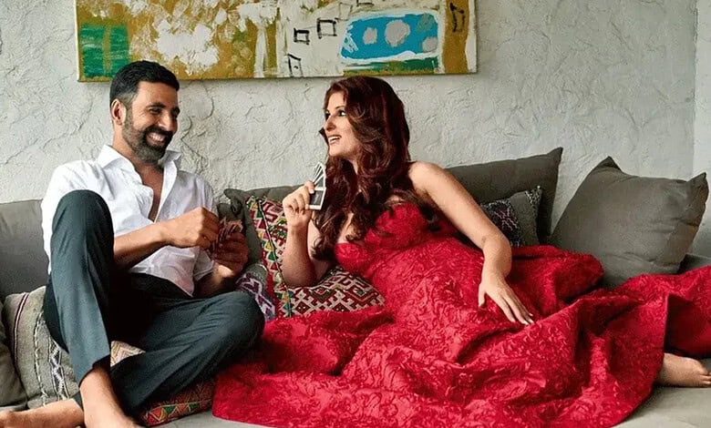 Happy couple relaxing on sofa, woman in red dress, man in white shirt, modern living room.