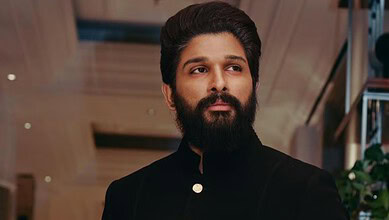 Allu Arjun with a beard in a black outfit at an indoor event.