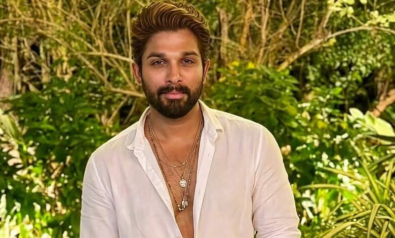 Allu Arjun in a white shirt with a lush green background, looking at the camera.