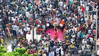 Crowd celebrating Golconda Bonalu festival with traditional dance and offerings in Hyderabad.