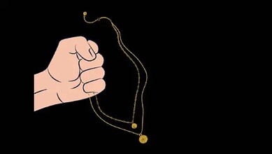 Hand holding a gold chain with a pendant against a black background.
