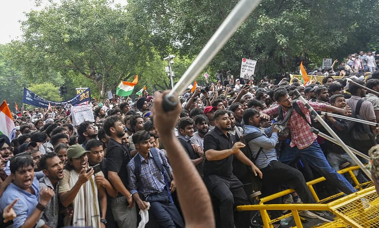 Large crowd of protesters gathered with flags and banners during a demonstration.