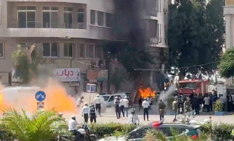 Emergency responders tackle a fire after explosions near a hotel hosting French President Emmanuel Macron in Damascus, Syria.