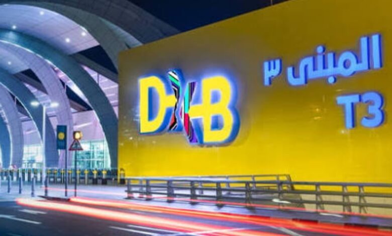 Dubai airport T3 entrance with bright yellow wall and illuminated signage for travellers.