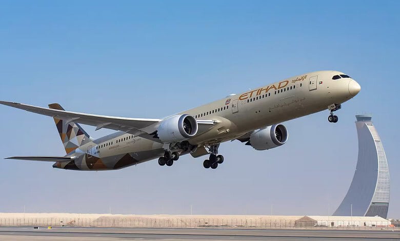 Etihad Airways Boeing 787 aircraft taking off with Dubai skyline in background.
