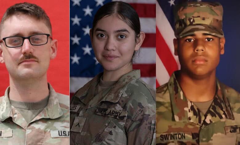 Three US military personnel in uniform with American flags in the background.