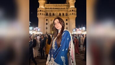 Farrhana Bhatt in a blue traditional dress at Charminar during night time.