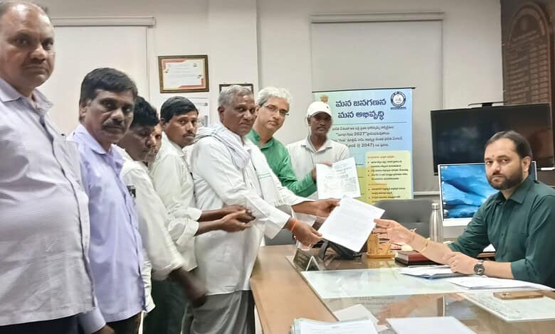 Group of men receiving documents from a man at a desk in an office setting.